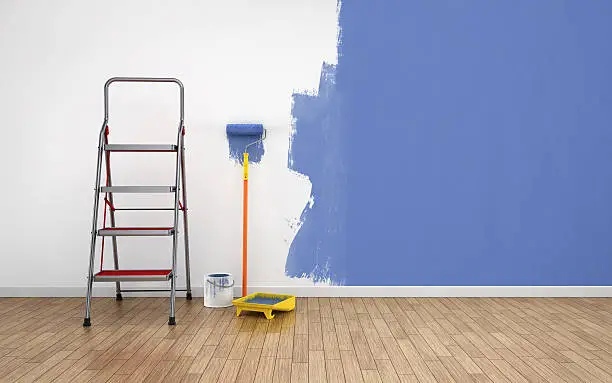 Painting walls of an empty room. Renovation house.