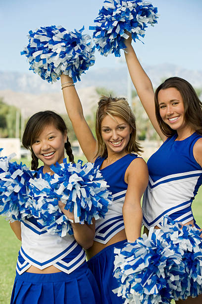 istock Cheerleaders in Uniform Holding Pom-Poms 468843899