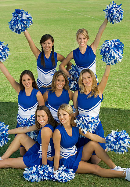 istock Cheerleaders Holding Pompoms On Field 468843915