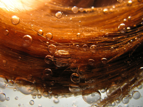 Floating hair in water with bubbles