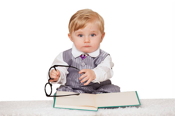 istock Nerdy baby boy reading a book 468847210