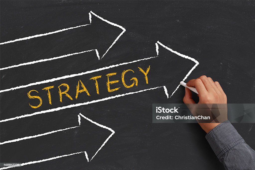 Strategy Concept A businessman is drawing strategy concept with arrows on blackboard. 2015 Stock Photo
