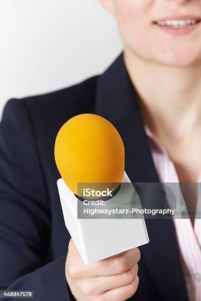 Abstract Shot Of Female Journalist With Microphone Stock Photo - Download Image Now - 20-29 Years, 2015, Adult