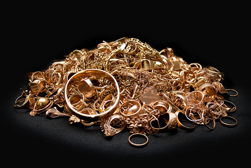 Scrap gold jewelry on black background