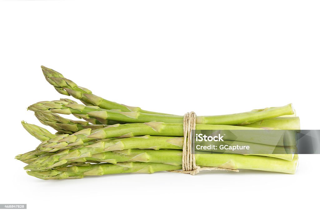 uncooked green asparagus tied with twine, isolated on white 2015 Stock Photo