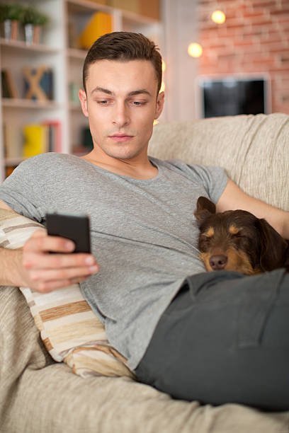 istock Young man at home with his dog. 468851460