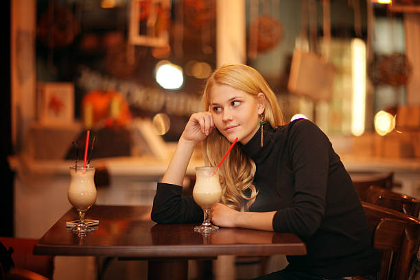 istock cheerful girl drinking coffee in a cafe at night 468851860
