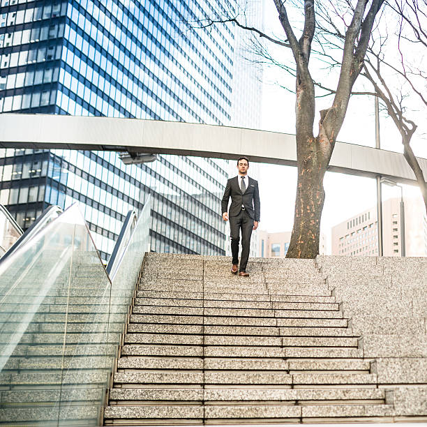 istock business man descending the steps on wall street 468852434
