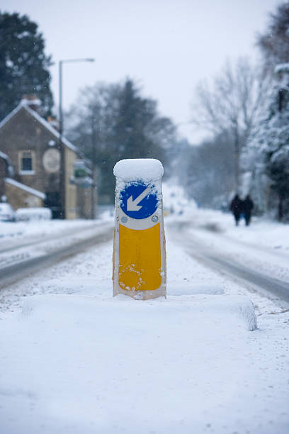 istock Road bollard in a central reservation covered in snow 468852804