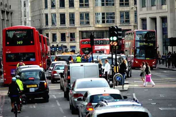 Photo of Cars in traffic and people crossing