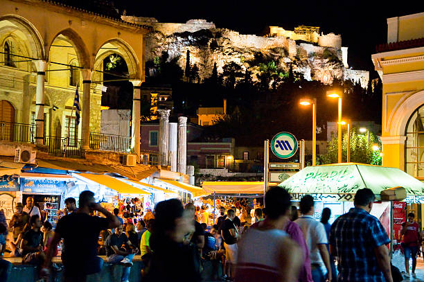Nightlife on Monastiraki Square, Acropolis of Athens on the background. stock photo