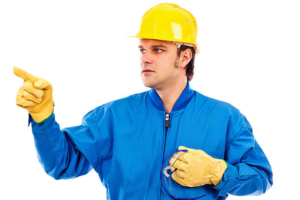 Portrait of a young construction worker pointing something