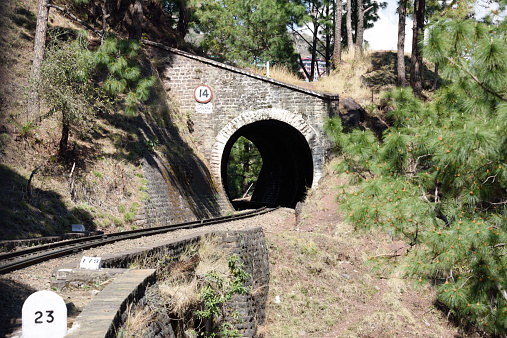 Kalka, India - March 17, 2015: Tunnel 14 near Jabli on the Kalka Shimla Railway in northern-western India, one of 102 tunnels built on the line as it climbs through the lower Himalayas. The railway, built to 2 ft 6 in (762 mm) narrow gauge, runs for 96 kilometers from Kalka, on the broad gauge line from Delhi, to Shimla in the south-western Himalayan ranges.