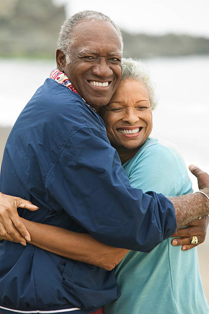 istock Couple Embracing Each Other On Beach 468859995