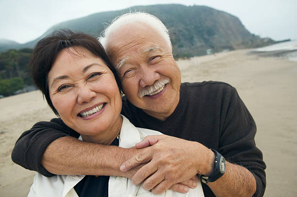 istock Couple Embracing Each Other On Beach 468860419
