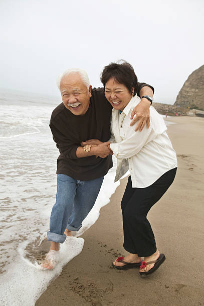 istock Couple Embracing Each Other On Beach 468860445