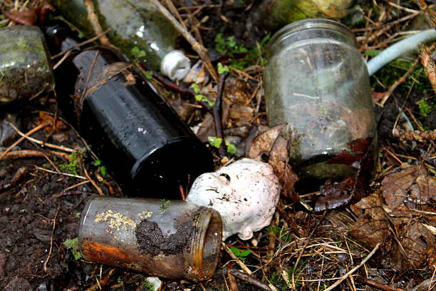 istock Glass jars and bottles and dolls head at old tip 468861436