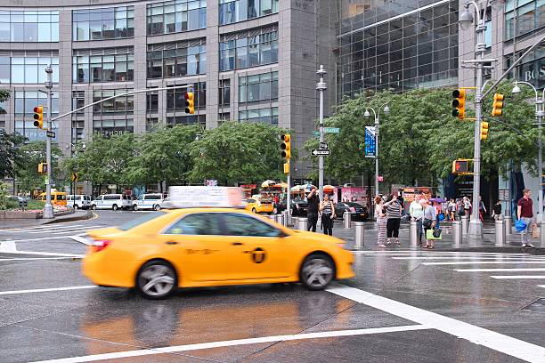 Columbus Circle New York, United States - July 3, 2013: Taxi drives at Columbus Circle in New York. Columbus Circle with famous Time Warner Center skyscrapers completed in 2003 is one of New York landmarks. time warner center columbus circle pictures stock pictures, royalty-free photos & images