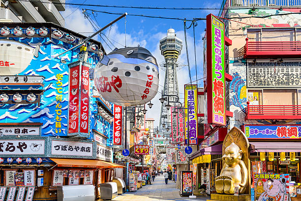 Osaka Japan at Shinsekai District Osaka, Japan - November 21, 2012: Pedestrians walk through the Shinsekai District. The district was created in 1912 with New York and Paris serving as models. osaka prefecture stock pictures, royalty-free photos & images