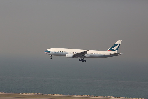 Hong Kong, Сhina - December 2, 2013: the plane is landing in Hong Kong international airport on 29 Nov 2014. it also called Chek Lap Kok Airport, it is the main airport in Hong Kong.