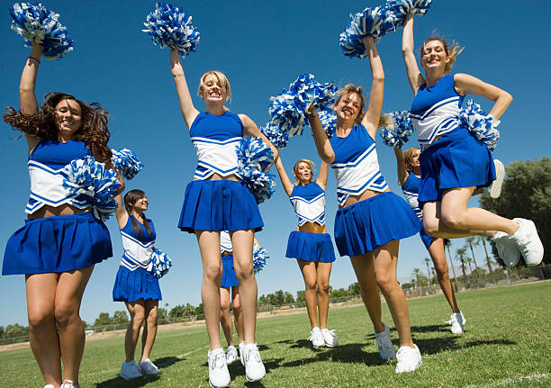 istock Cheerleaders With Pompoms Cheering On Field 468862969