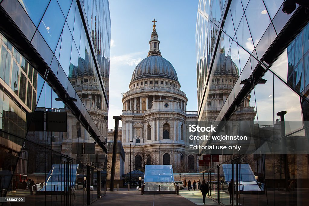 View of St Paul's Cathedral from the One New Change London, England - March 10, 2015: View of St Paul's Cathedral, People can be seen Blue sky and Cathedral. St Paul's is reflected in the glass of the buildings of the Retail Centre One New Change 2015 Stock Photo