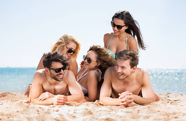 istock Happy friends relaxing on the beach during summer day. 468864084