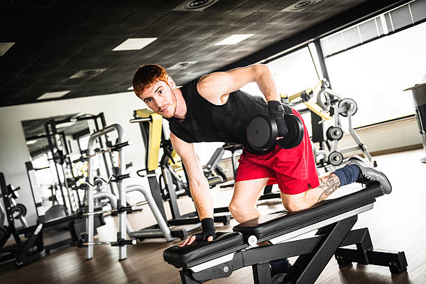 istock Red head man training with dumbell on gym 468864242