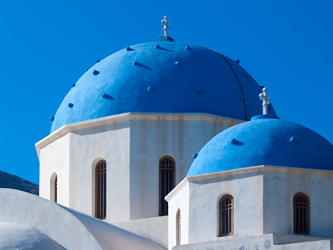 The blue domed roof of a classic Greek church on the island of Santorini.
