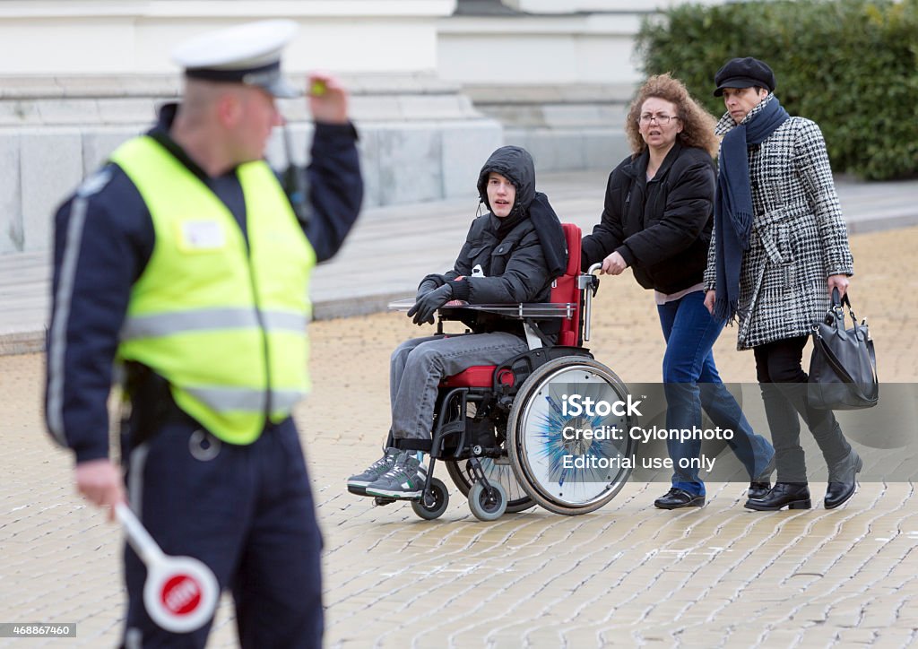 Physical Impairment (Disabled) people protest Sofia, Bulgaria - April 3, 2015: A mother and her son are going to a protest with other parents and relatives of physically disabled children and adults against state laws which they considere discriminatory. Disability Stock Photo