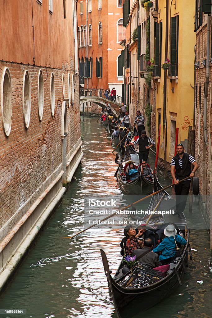 Gondole at Venice Venice,Italy - April 18, 2014: In St Mark's canal gondoliers are waiting to download tourists for the end of their tour 2015 Stock Photo