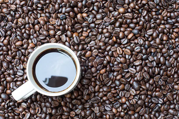 Cup of coffee, on the coffee beans background