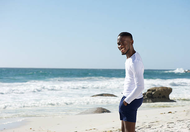 istock Happy african american man smiling at the beach 468874074