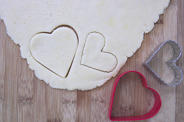 istock Sugar cookie dough with heart shaped cookie cutters 468876514
