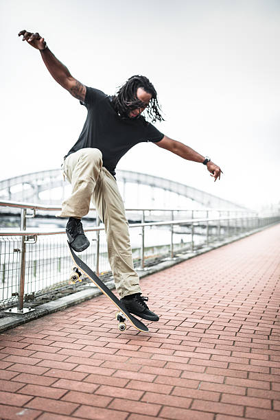 istock happiness african man skating and doing some trick 468877532