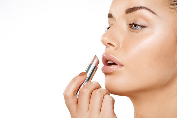 istock applying lipstick beautiful woman 468878579