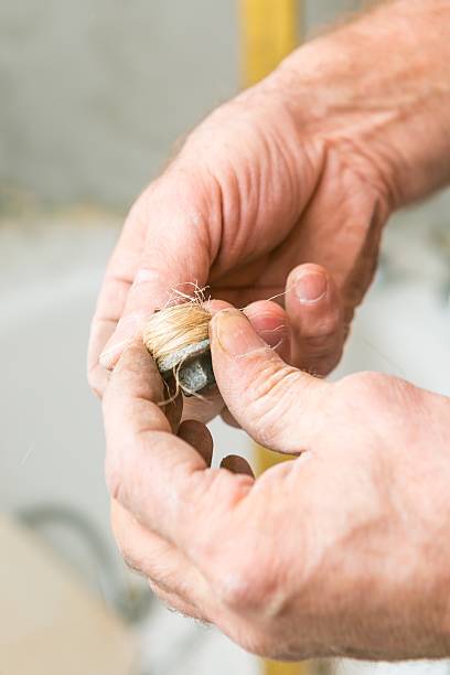 istock Plumber hand with seal laging 468880432