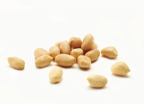 A pile of salted peanuts, isolated on a white background