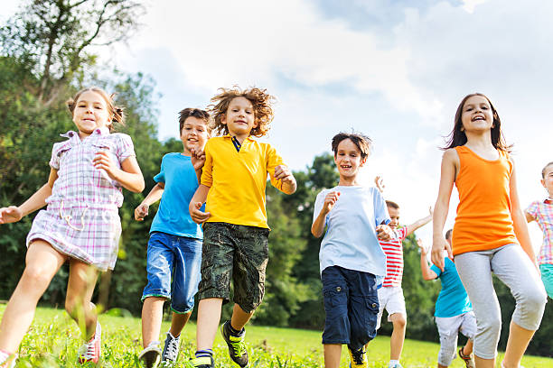 istock Low angle view of children running in the park. 468880838