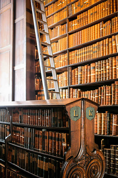 Trinity College Library Dublin Dublin, Eire - November 17, 2013: Thousands of books on shelves inside the Trinity College Library Dublin, Part of the University of Dublin trinity college library stock pictures, royalty-free photos & images