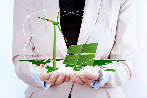 istock Solar Panel and Wind Turbine in women's hands 468884734