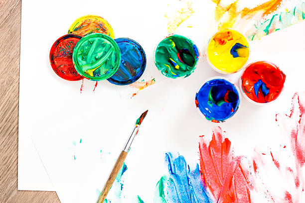 istock Opened paints and paintbrush on messy paper. 468884969