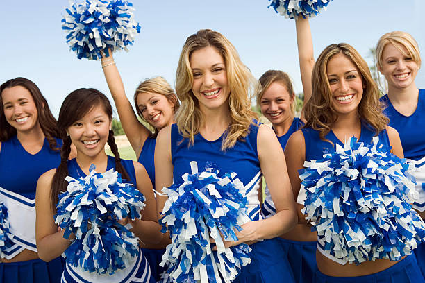 istock Cheerleading squad dressed in blue and white pose for photo 468885449