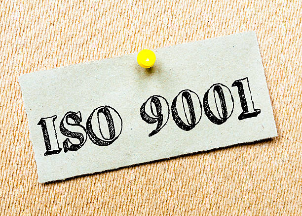 ISO 9001 Message Recycled paper note pinned on cork board. ISO 9001 Message. Concept Image 2015 stock pictures, royalty-free photos & images