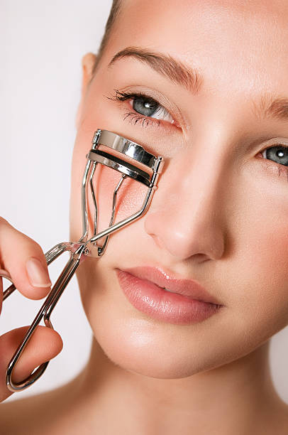 istock Beauty Woman with eyelash curler 468887725