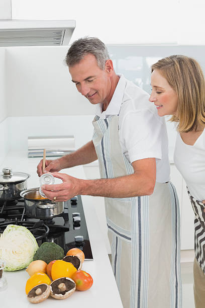 istock Side view of a couple preparing food in kitchen 468888068