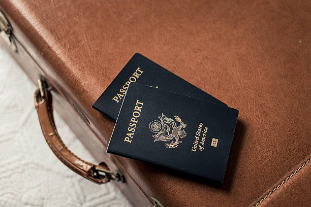 istock Old Fashioned Suitcase on a Bed with Passports 468888431