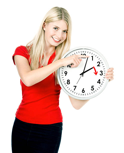 istock Time management concept. Daylight Saving Time. Young smiling woman 468890772