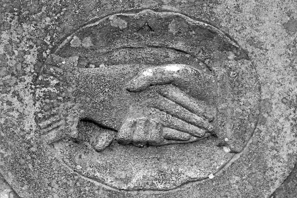 Photo of Stone engraving of a 2 hands shaking