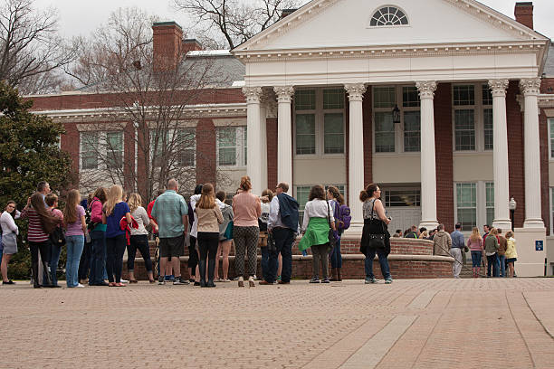 Prospective college students and their families take campus tour stock photo